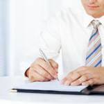 Businessman Writing On a Document